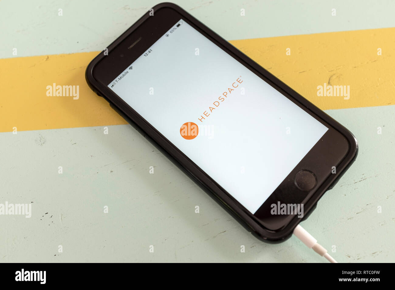 An iPhone showing the app Headspace on a blue and yellow backgorund