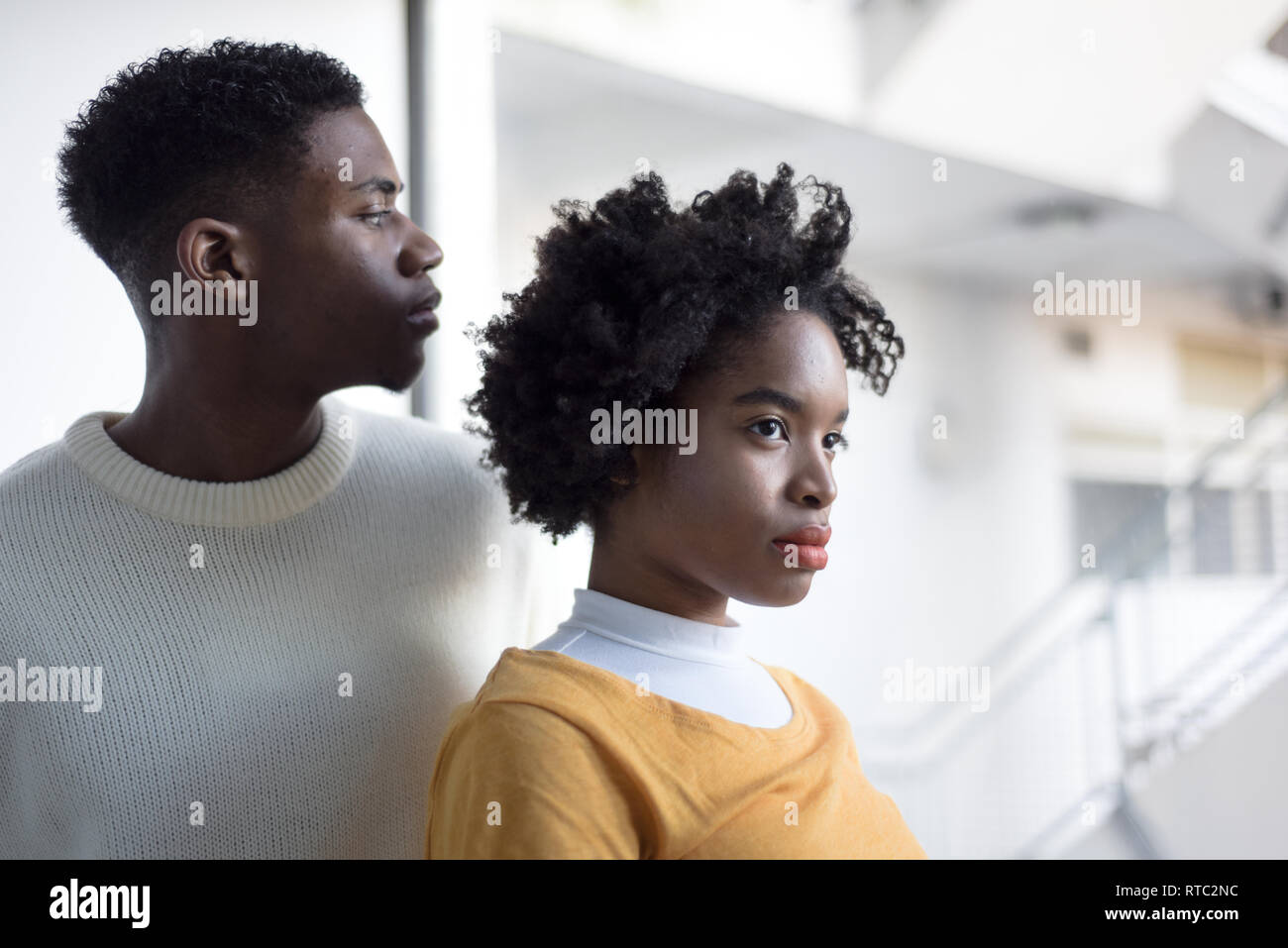 A Young Attractive Black Couple Looking Serious In A Simple White