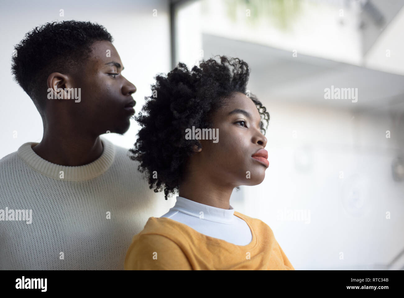 A Young Attractive Black Couple Looking Serious In A Simple White