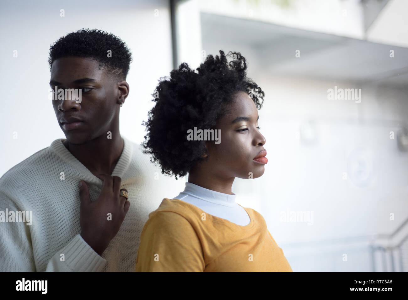 A Young Attractive Black Couple Looking Serious In A Simple White