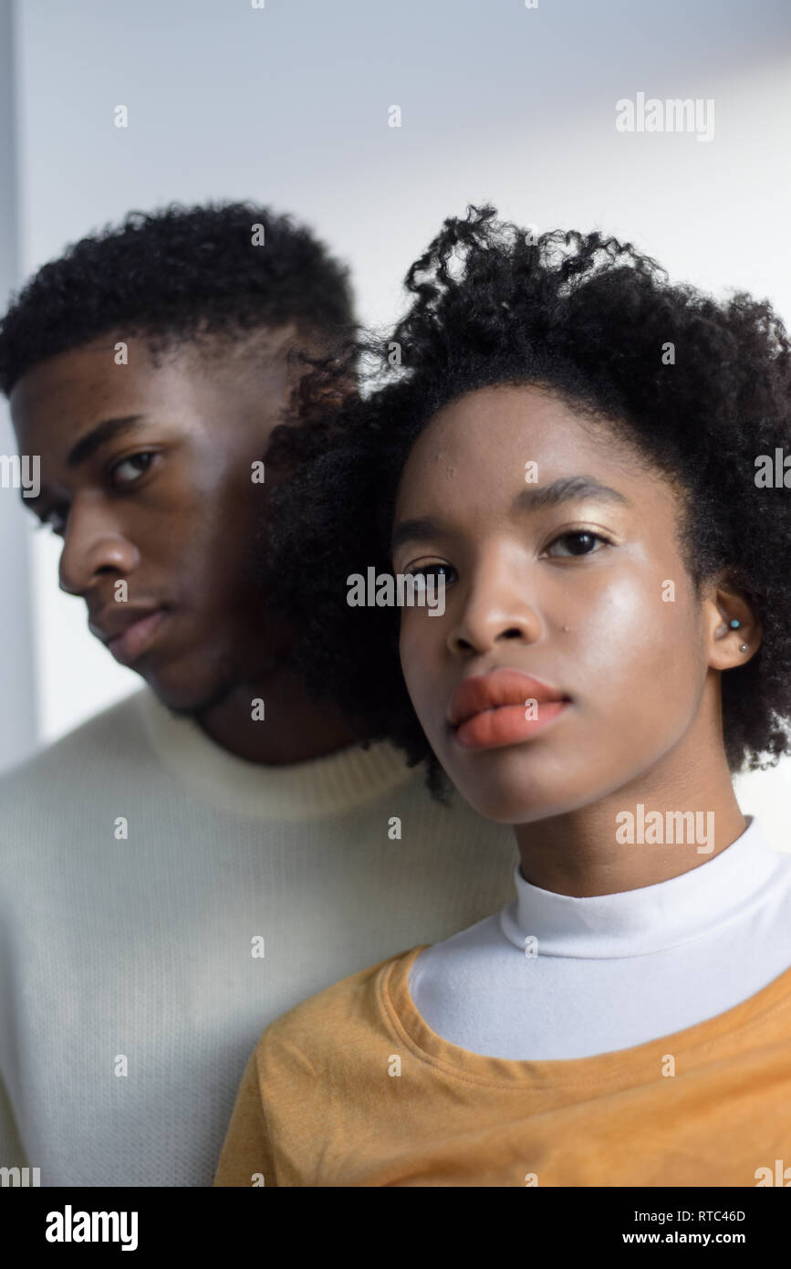 A Young Attractive Black Couple Looking Serious In A Simple White