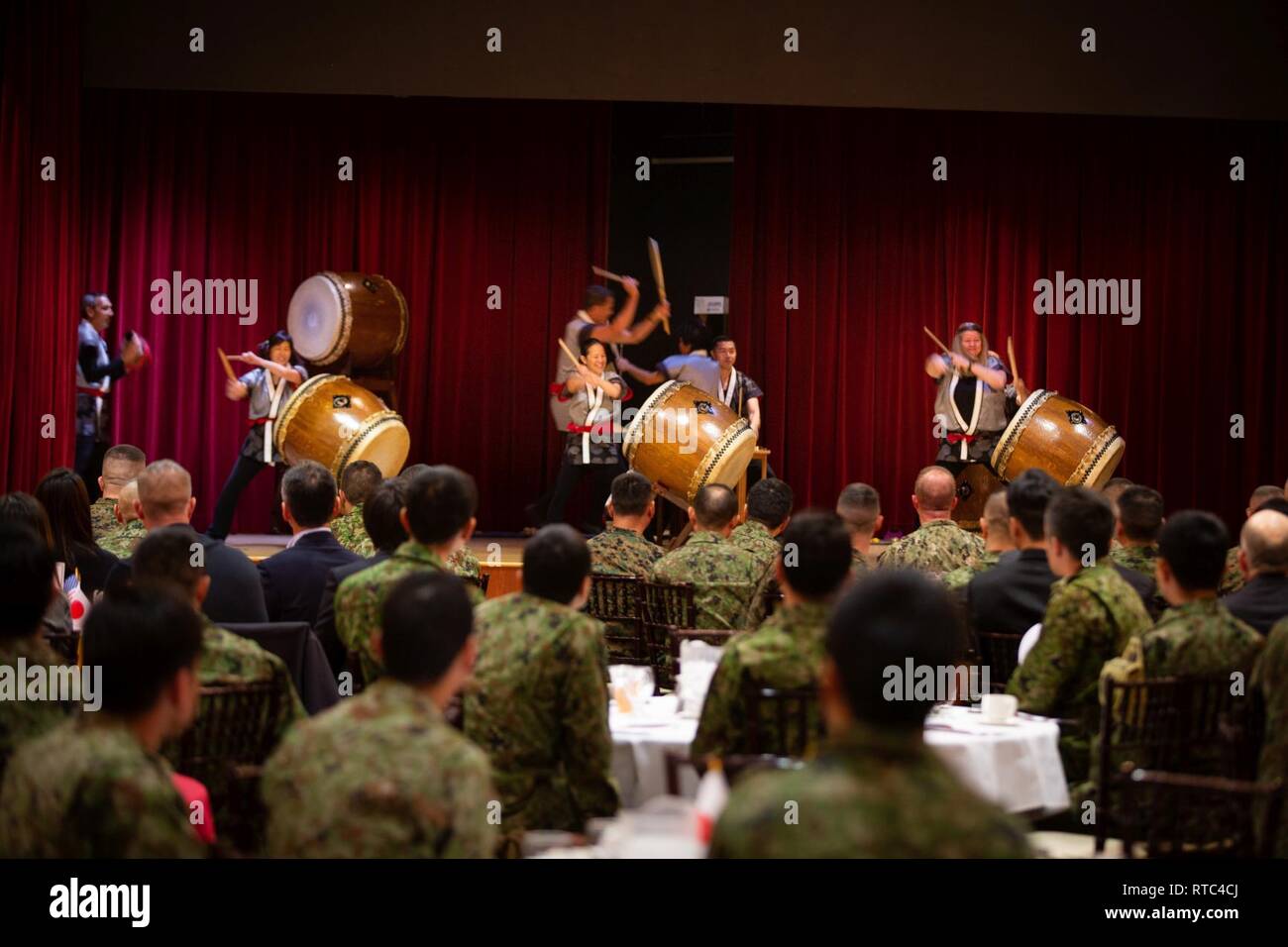 U.S. Marines and Japan Ground Self-Defense Force Soldiers watch a drum performance during the closing ceremony for exercise Iron Fist 2019, Feb. 8, on U.S. Marine Corps Base Camp Pendleton, Calif. Exercise Iron Fist is an annual, multilateral training exercise where U.S. and Japanese service members train together and share techniques, tactics and procedures to improve their combined operational capabilities. Stock Photo