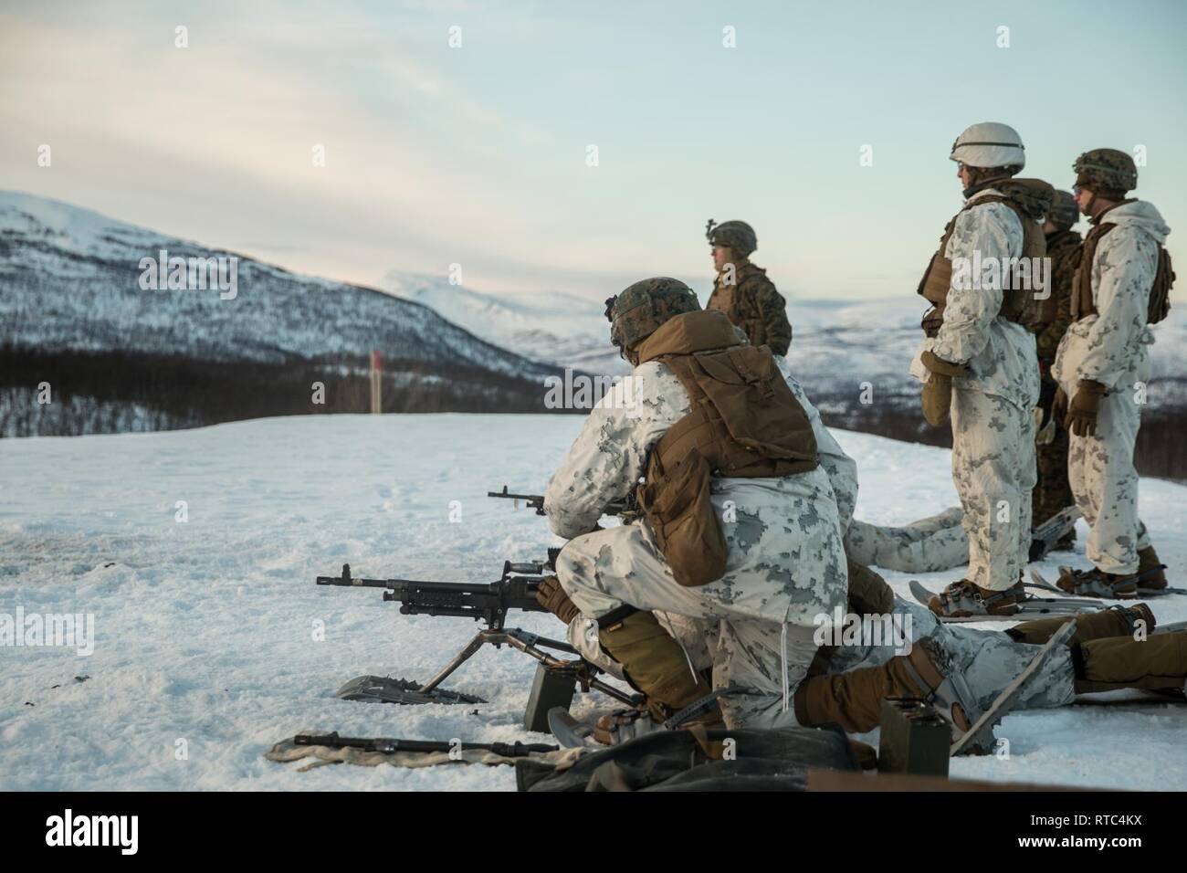 U.S. Marines with Marine Rotational Force-Europe 19.1, Marine Forces Europe and Africa, conduct live-fire with a M240B machine gun in Setermoen, Norway, Feb. 8, 2019. This training increased MRF-E Marines’ proficiency at cold-weather and mountain-warfare tactical operations in cold-weather environments. Stock Photo