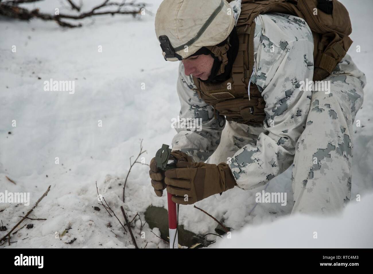 A U.S. Marine with Marine Rotational Force-Europe 19.1, Marine Forces Europe and Africa, aligns the front and rear stabilizing stacks using a compass in Setermoen, Norway, Feb. 8, 2019. This training increased MRF-E Marines’ proficiency at cold-weather and mountain-warfare tactical operations in cold-weather environments. Stock Photo