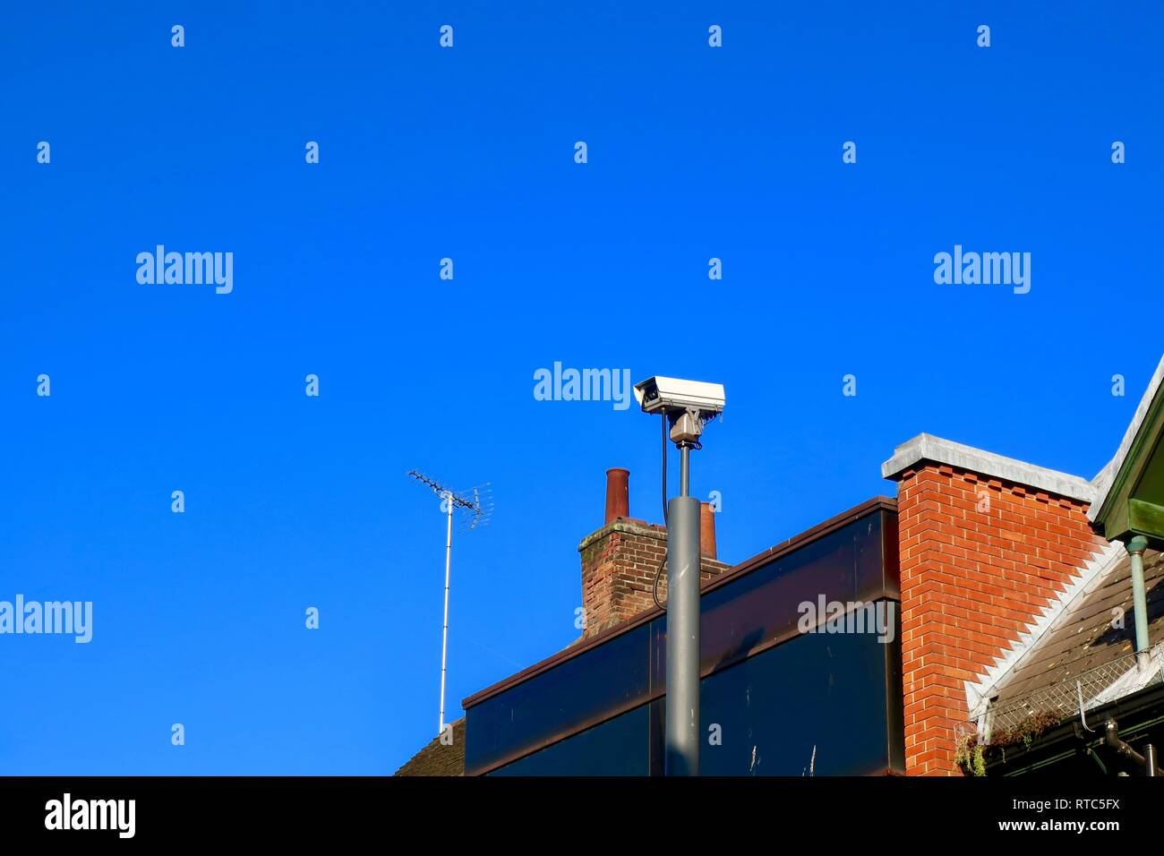 Big Brother is watching you. CCTV camera high above the rooftops in Ipswich, Suffolk, UK. February 2019. Stock Photo