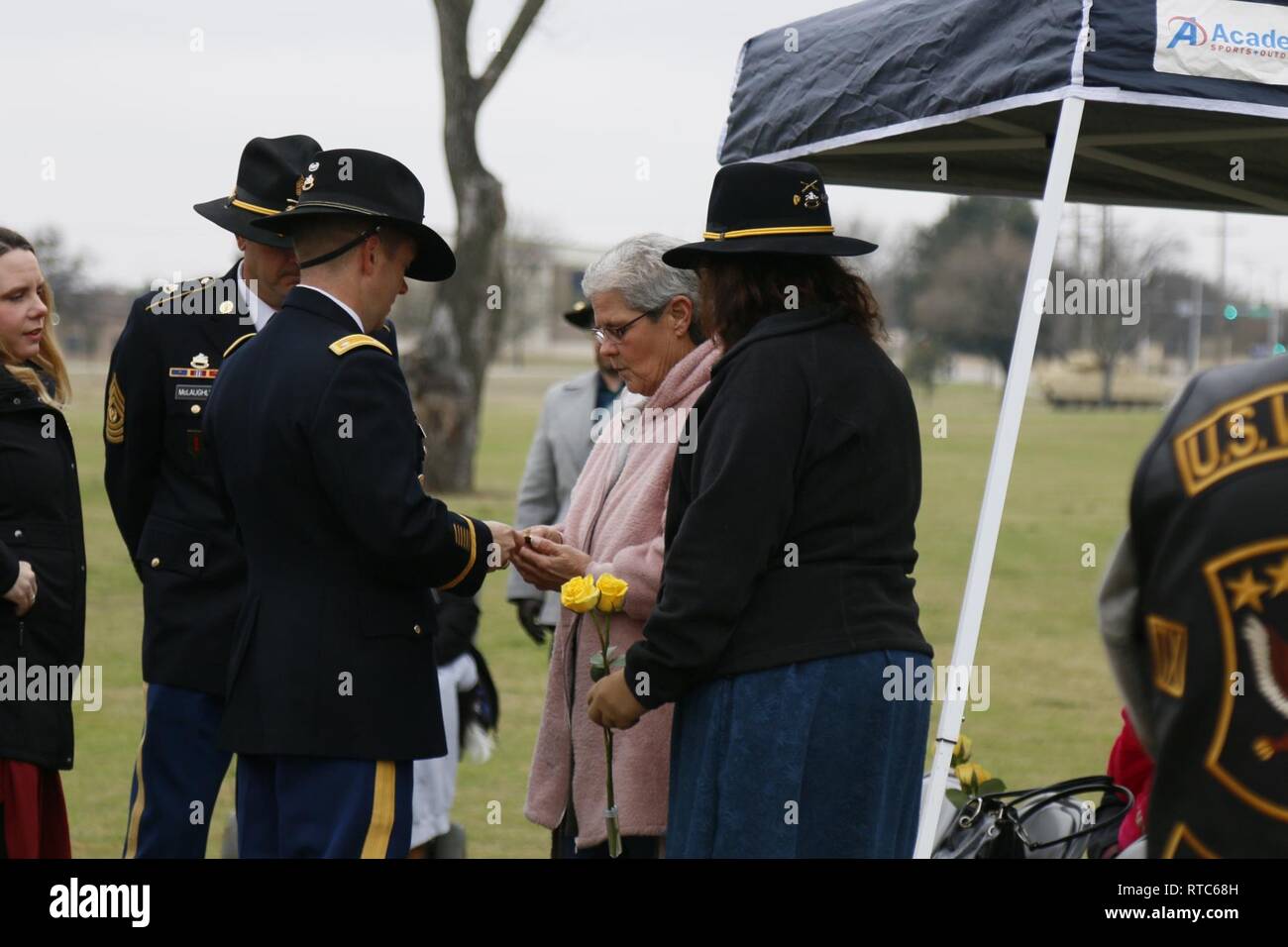 Lt. Col. Kevin Black, battalion commander, offers a coin to Goldstar Mothers Ms. Patti Ward and Ms. Cathy Mcfarlane. Their sons along with two other Soldiers were killed Feb. 9, 2009. Lt. Col. Gary Derby, Sgt. Joshua Ward, Pvt. 1st Class Albert Jex and Pvt. 1st Class Jonathan Roberge were killed when a vehicle borne improvised explosive device hit their vehicle. Derby was the battalion commander for 3rd Battalion, 8th Cavalry Regiment, 3rd Armored Brigade Combat Team, 1st Cavalry Division and the three Soldiers were part of his security detachment. Stock Photo