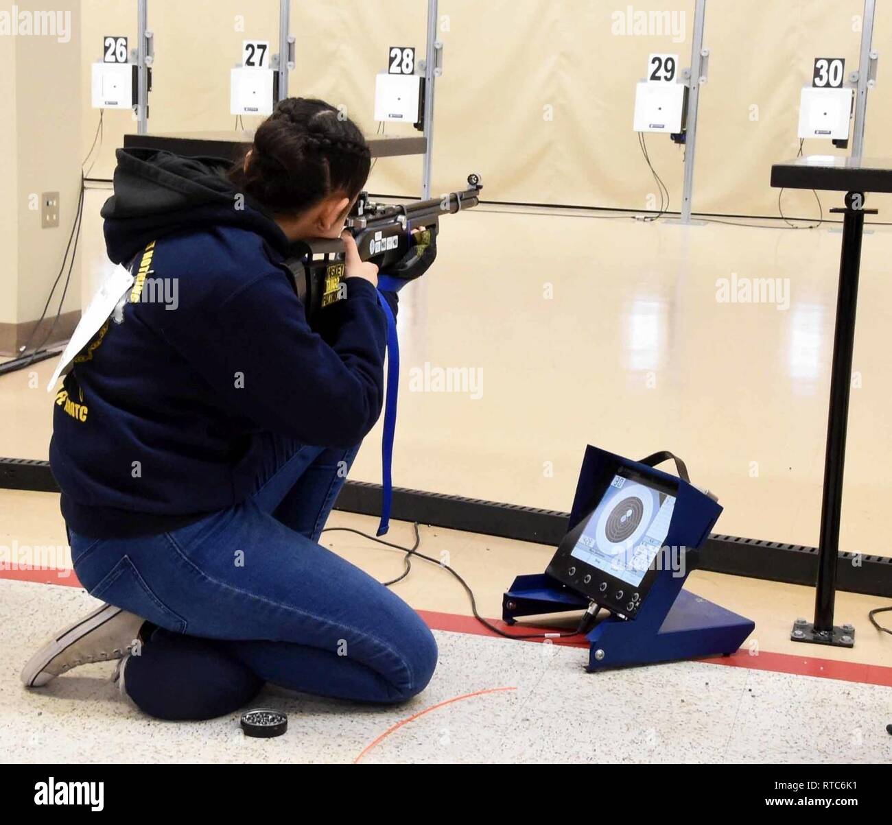 ANNISTON, Ala., (February 9, 2019) – Navy Junior Reserve Officers Training Corps (NJROTC) Cadet Mya Gonzalez, from Santa Fe, New Mexico High School, fires in the kneeling position during the Sporter Division portion of the NJROTC Air Rifle Championship in Anniston, Ala., Feb. 8-9. Santa Fe was the winning Sporter Division unit in this year’s competition that included nearly 200 NJROTC cadets from high schools across the United States. Stock Photo