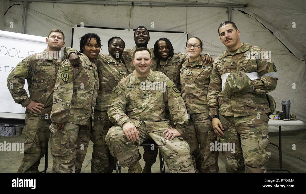 Soldiers from the 300th Sustainment Brigade takie a picture after participating in the junior enlisted council at Camp Arifjan, Kuwait, Feb. 9, 2019. Stock Photo