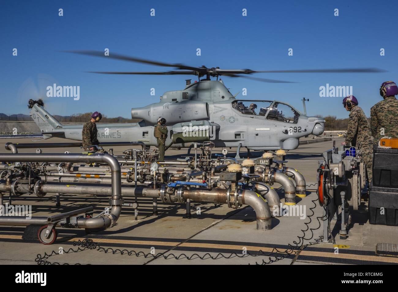 U.S. Marines with Headquarters & Headquarters Squadron, Marine Corps Air Station Camp Pendleton, refuel an AH-1Z Viper helicopter at Marine Corps Air Station (MCAS) Camp Pendleton, California, Feb. 11, 2019. MCAS Camp Pendleton Bulk Fuel Specialists receive, store and dispense fuel to aircraft supported by the air station. Stock Photo