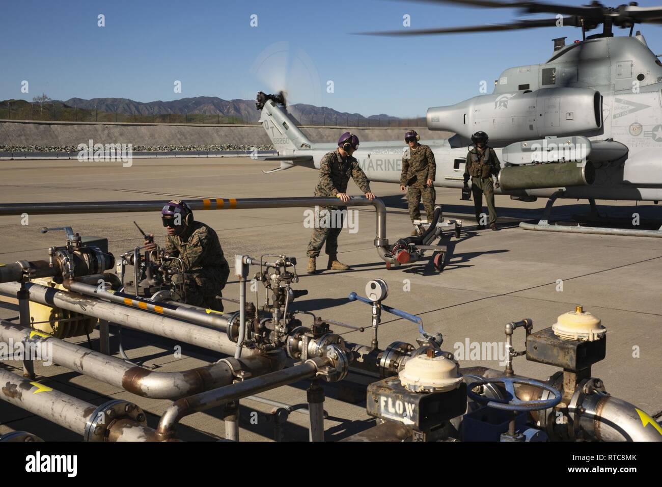 U.S. Marines with Headquarters & Headquarters Squadron, Marine Corps Air Station (MCAS) Camp Pendleton,refuel an AH-1Z Viper helicopter at MCAS Camp Pendleton, California, Feb. 11, 2019. MCAS Camp Pendleton Bulk Fuel Specialists receive, store and dispense fuel to aircraft supported by the air station. Stock Photo