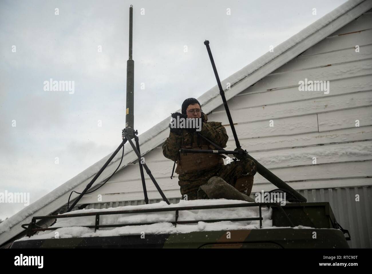 A U.S. Marine with Marine Rotational Force-Europe 19.1, Marine Forces Europe and Africa, sets up communication capabilities on a Bandvagn 206 during Exercise Snow Panzer in Setermoen, Norway, Feb. 11, 2019. Snow Panzer is a force-on-force bilateral exercise between MRF-E and the Panzer Battalion of Brigade Nord. Stock Photo