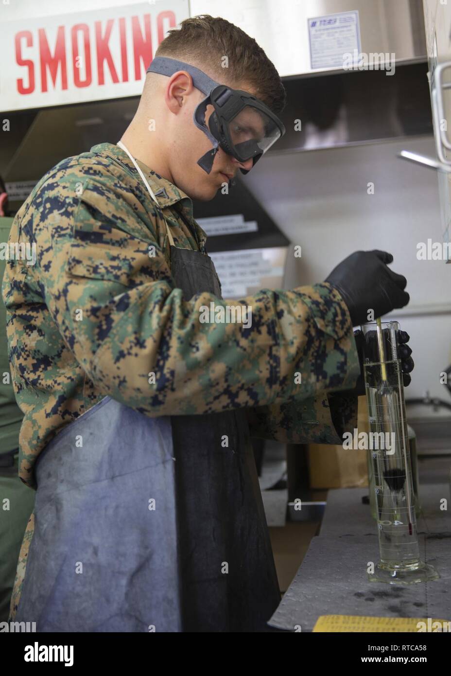 U.S. Marine Corps Lance Cpl. Chance Rogers, bulk fuel specialist, Headquarters & Headquarters Squadron, Marine Corps Air Station (MCAS) Camp Pendleton, examines the tempurature of fuel at MCAS Camp Pendleton, California, Feb. 12, 2019. Every morning, bulk fuel specialists gather samples to ensure fuel is clear of harmful contaminants. Stock Photo