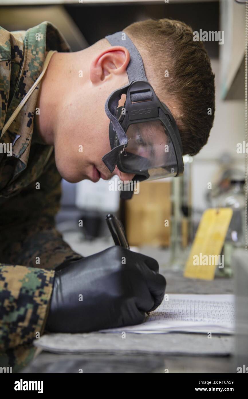 U.S. Marine Corps Lance Cpl. Chance Rogers, bulk fuel specialist, Headquarters & Headquarters Squadron, Marine Corps Air Station (MCAS) Camp Pendleton, logs fuel sample temperatures at MCAS Camp Pendleton, California, Feb. 12, 2019. Every morning, bulk fuel specialists gather samples to ensure fuel is clear of any harmful contaminants. Stock Photo