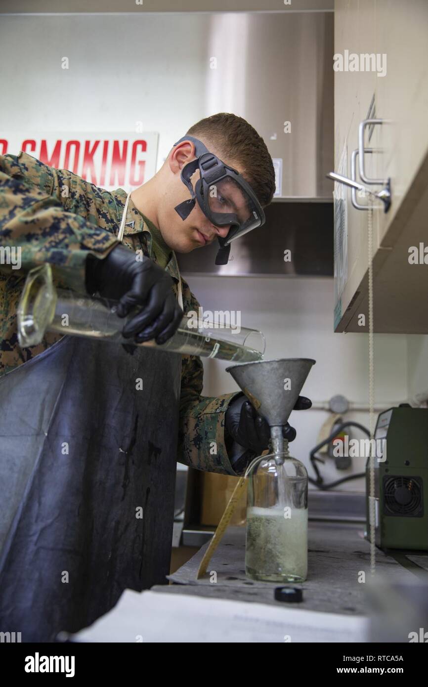 U.S. Marine Corps Lance Cpl. Chance Rogers, bulk fuel specialist, Headquarters & Headquarters Squadron, Marine Corps Air Station (MCAS), Camp Pendleton, logs in temperatures of fuel at MCAS Camp Pendleton, California, Feb. 12, 2019. Every morning, bulk fuel specialists gather samples to ensure fuel is clear of any harmful contaminants. Stock Photo