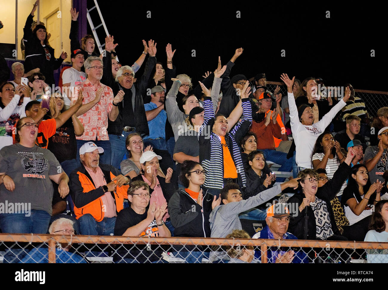 Refugio High School football fans leap to their seats as the team scores, Sept. 29, 2017, in Seguin, Texas. They lost to Navarro High School 21-17. Stock Photo