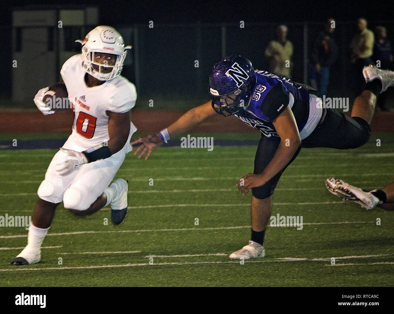 Refugio High School running back Jacobe Avery runs the ball as Navarro High School middle linebacker Ramon Munoz closes in for the tackle. Stock Photo