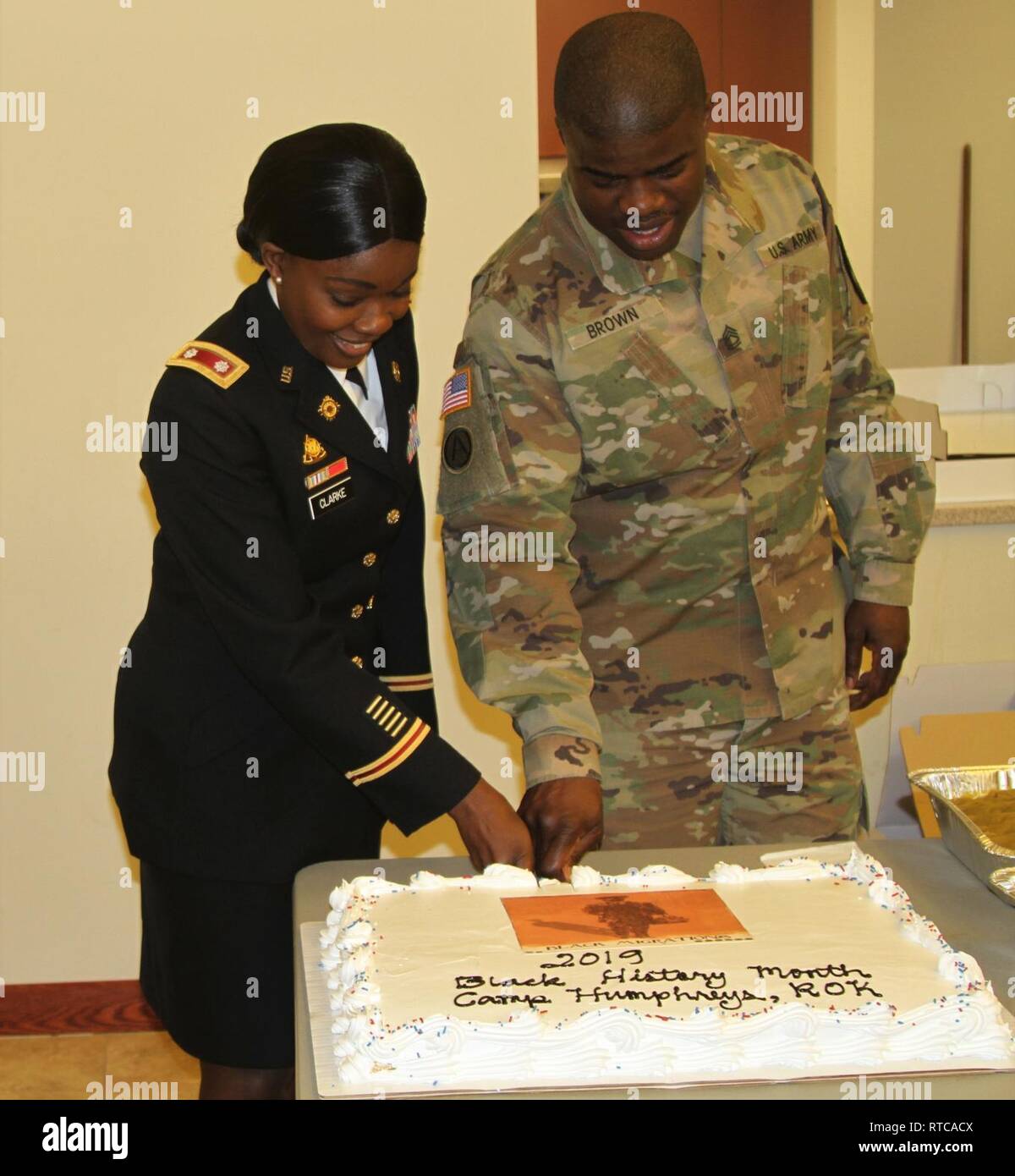 Lt. Col. Natasha Clarke, commander, 194th Combat Sustainment Support Battalion, 2nd Infantry Division, and Sgt.1st. Class Yukon Brown, Human Resources Company, Headquarters, and Headquarters Battalion, 2nd Infantry Division, cut the cake following the African-American History Month Observance on Feb.12, 2019, Camp Humphreys, Republic of Korea. Clarke was the guest speaker for this year's observance and spoke on Black Migration which highlighted African-American achievements in the United States. Stock Photo
