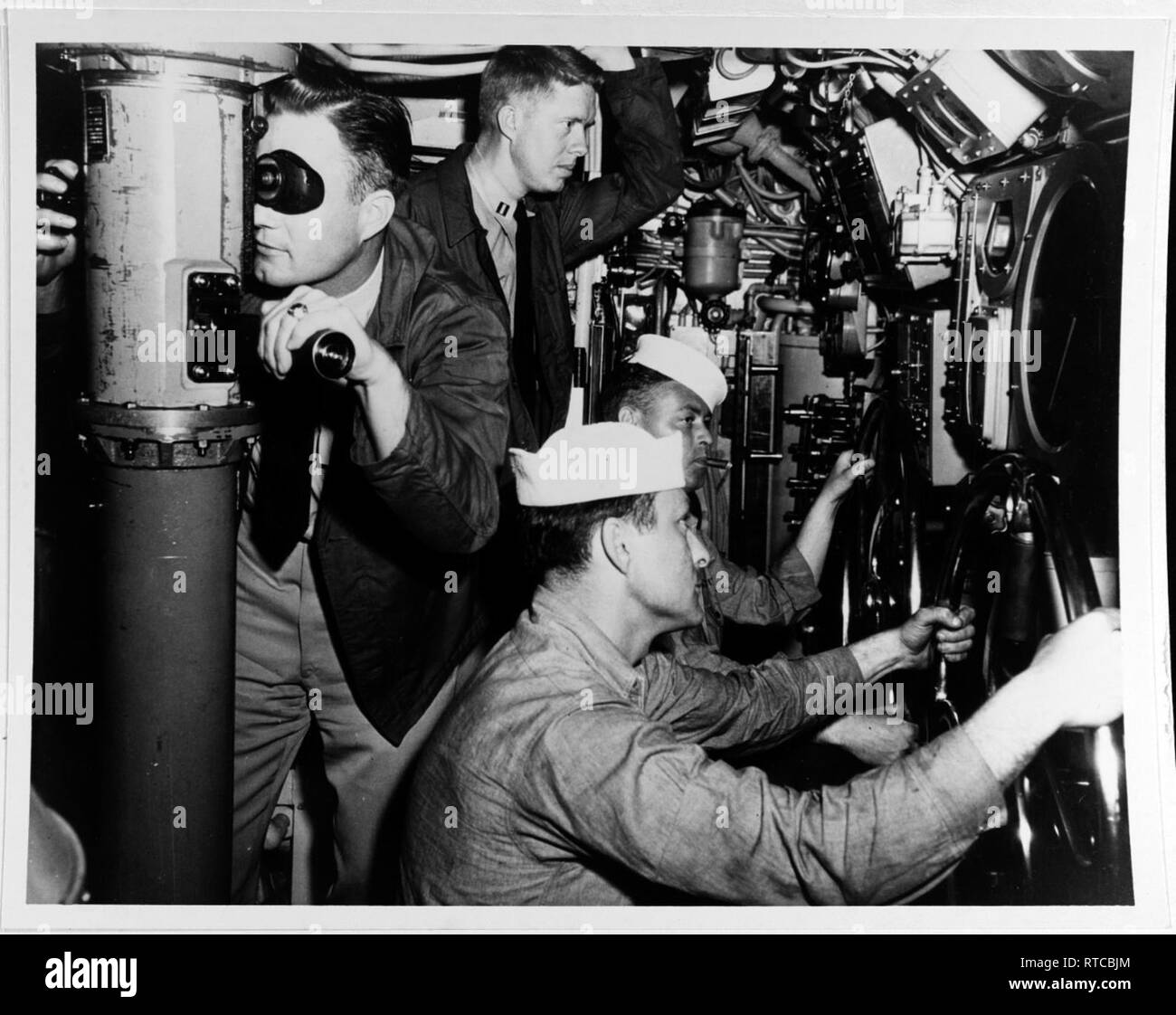 Jimmy Carter observes submariners in the main control room of submarine USS K-1 sometime between June and October 1952. Stock Photo