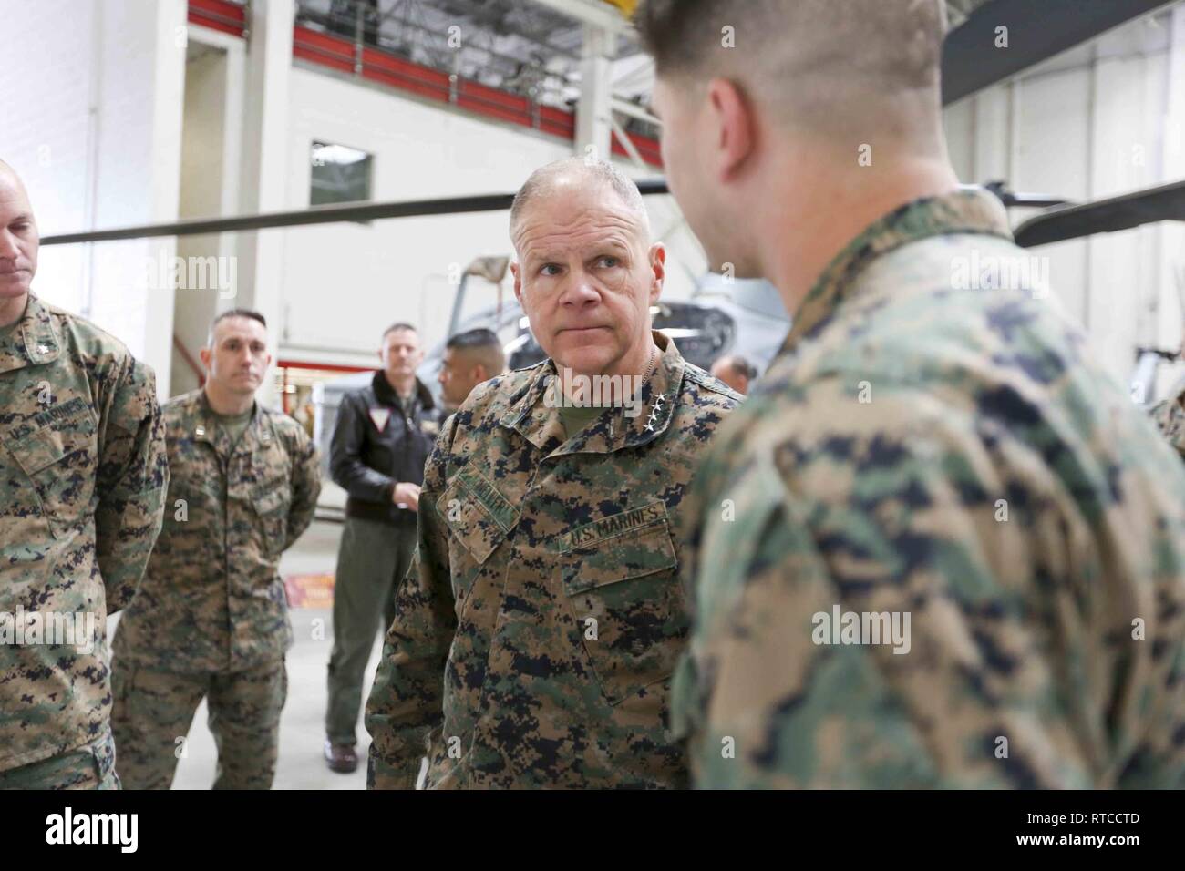 Commandant of the Marine Corps Gen. Robert B. Neller speaks with a Marine during a visit to Camp Pendleton, Calif., Feb. 13, 2019. Gen. Neller observed and discussed aviation maintenance and readiness. Stock Photo