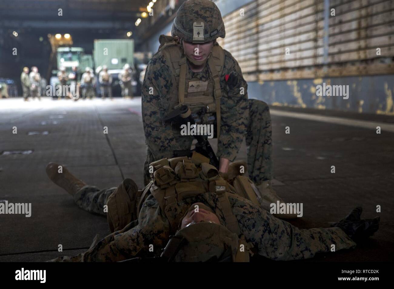 Lance Cpl. Dakota Weichers, a rifleman with Alpha Company, Battalion Landing Team, 1st Battalion, 4th Marines, practices lifesaving treatment during a Combat Lifesaver Course aboard the dock landing ship USS Ashland (LSD 48), East China Sea, Feb. 13, 2019. Weichers, a native of Kenosha, Wisconsin, graduated from Tremper High School in June 2017 before enlisting in June the same year. Alpha Company Marines are the small boat raid specialists for BLT 1/4, the Ground Combat Element for the 31st Marine Expeditionary Unit. The 31st MEU, the Marine Corps’ only continuously forward-deployed MEU partn Stock Photo