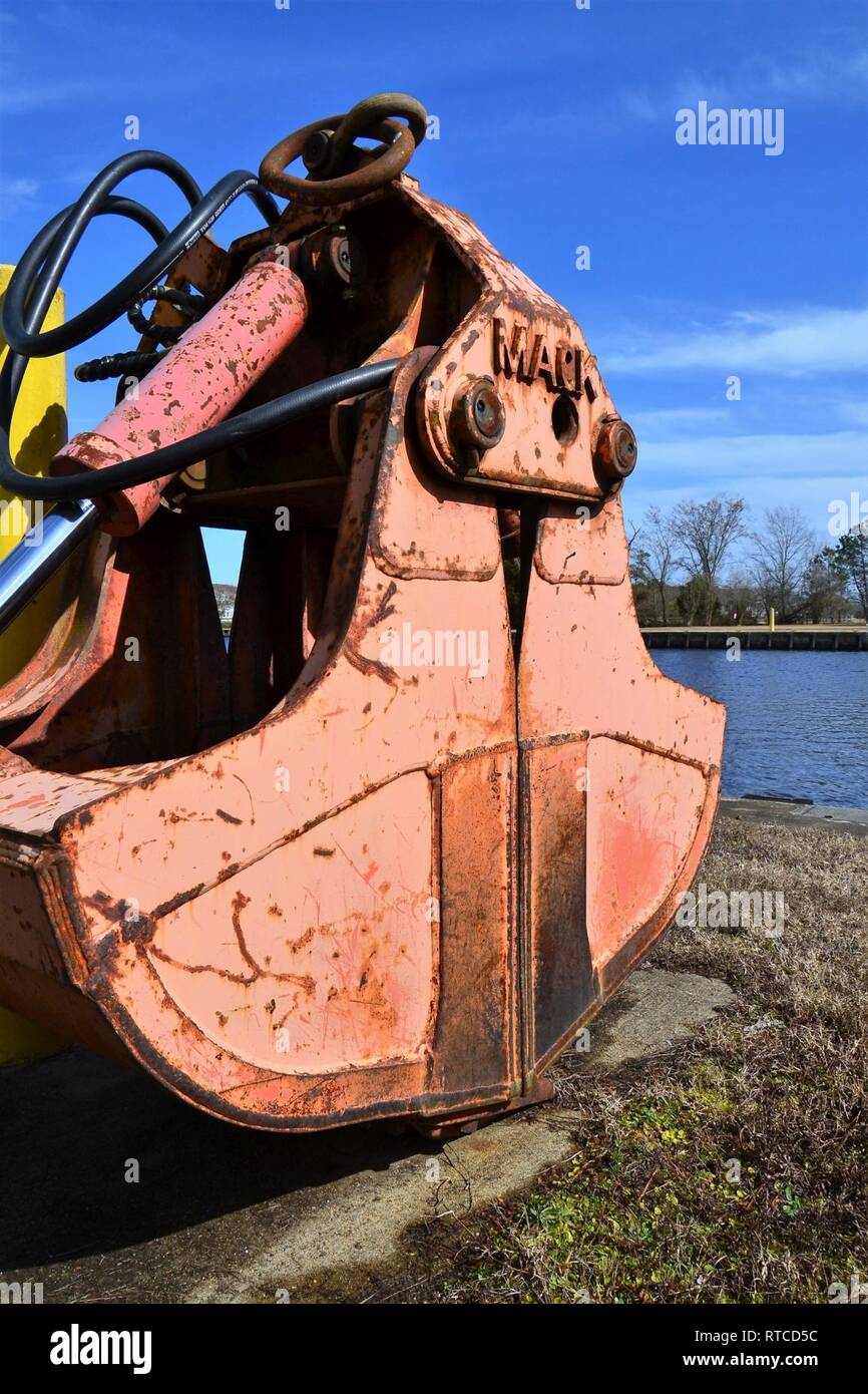 A clamshell bucket sits along Great Bridge Lock of the Atlantic Intracoastal Waterway, in Chesapeake, Virginia, Feb 13, 2019. The U.S. Army Corps of Engineers is slated to replace three of eight chamber valves along the AIWW. Stock Photo