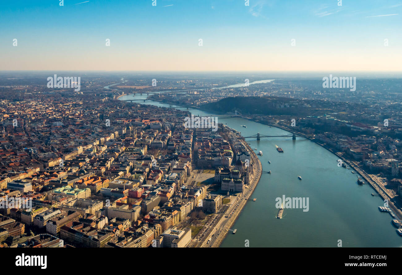 Image of areal view over the Hungarian capital city of Budapest with the river of danube and historical buildings and bridges during sunset Stock Photo
