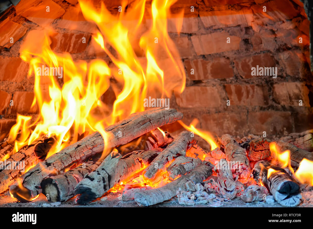 Pizza oven heating by burning beech and birch firewood providing high temperature and special smell, almoust done Stock Photo