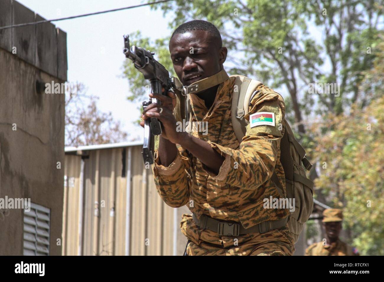 A Burkinabe platoon leader demonstrates tactical reload drills for his soldiers in preparation for participating in Exercise Flintlock 2019, near Po, Burkina Faso, Feb. 17, 2019. Flintlock is U.S. Africa Command's premier and largest special operations forces exercise. Stock Photo