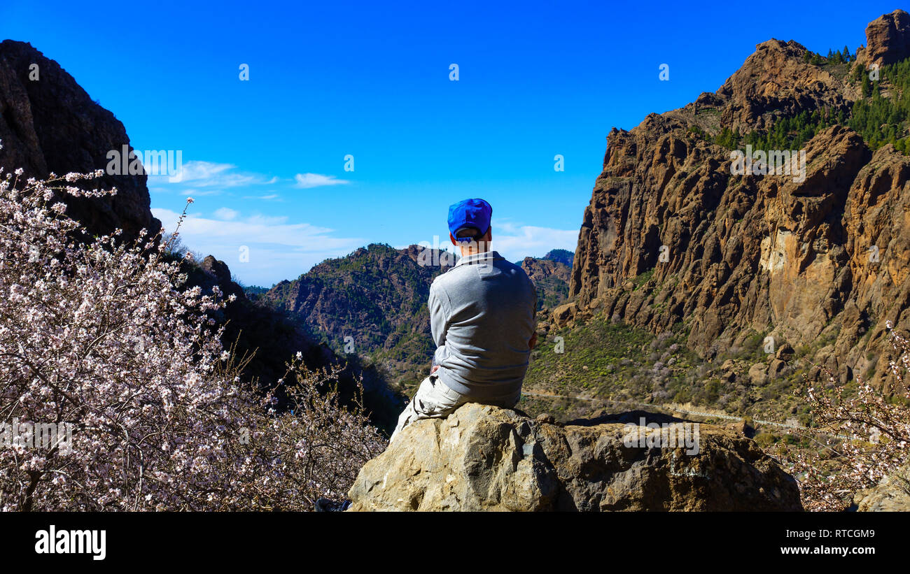 Man is watching the mountains in the springtime of Gran Canaria, Spain Stock Photo
