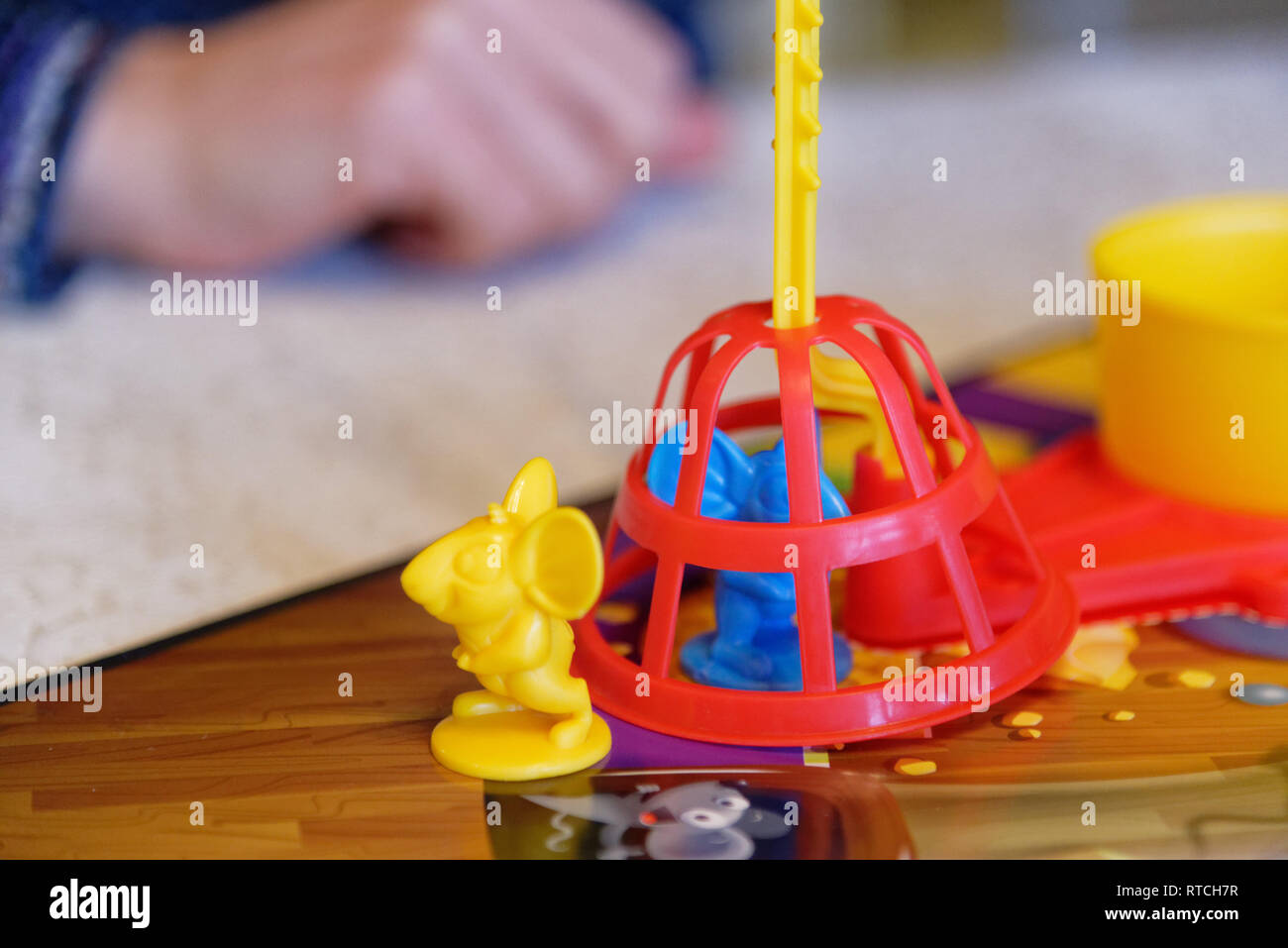 Trapped mouse playing piece in the Mouse Trap board game Stock Photo