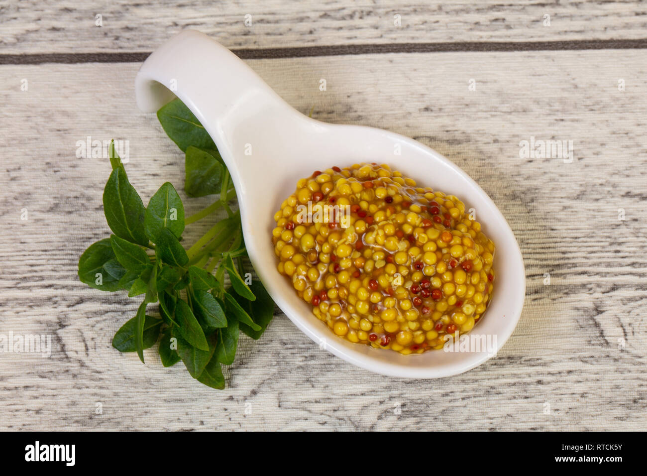 Traditionnal dijon mustard served basil leaves Stock Photo Alamy