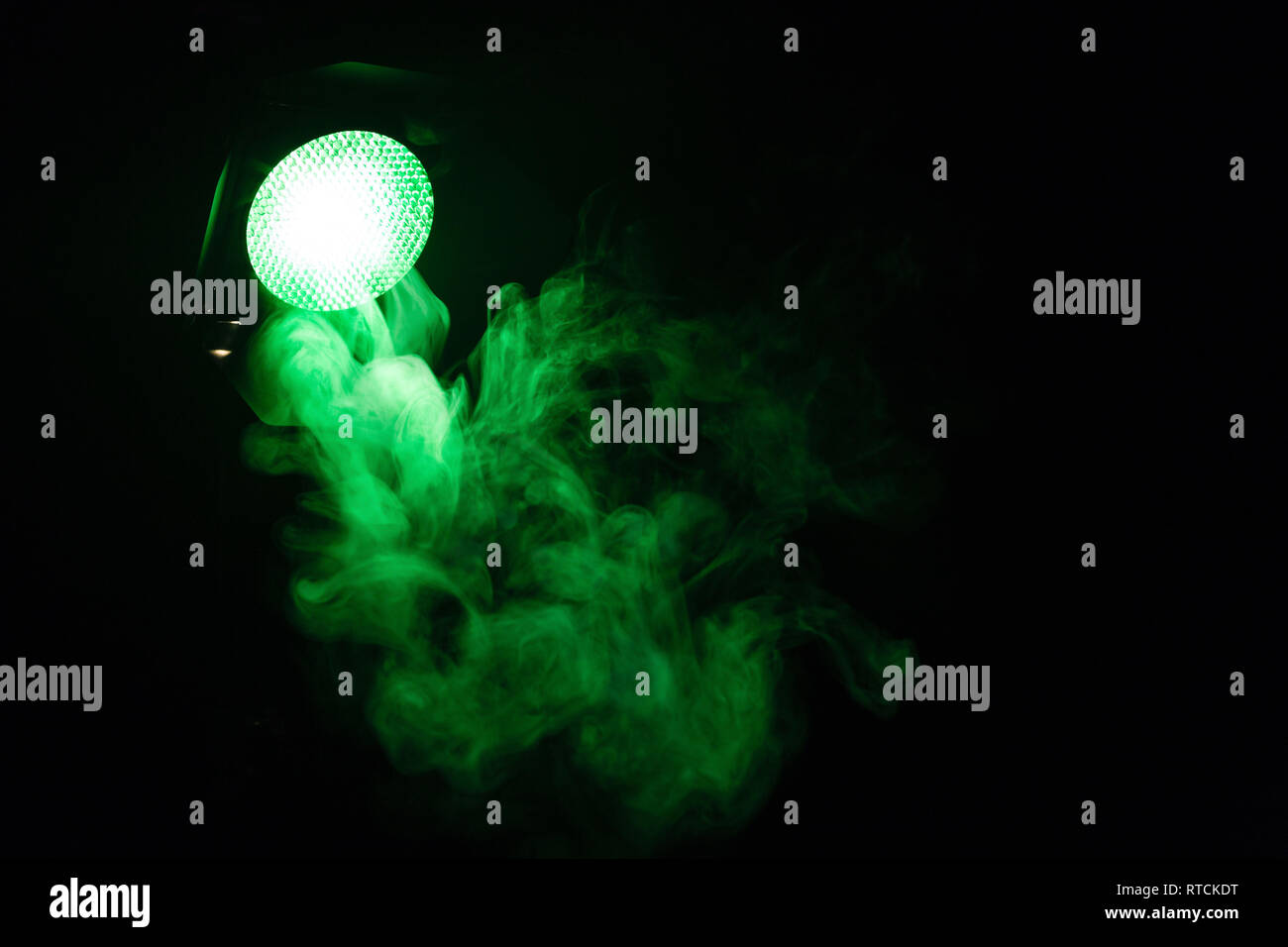 Green light with smoke on dark background. Equipment for photo Studio. Stock Photo