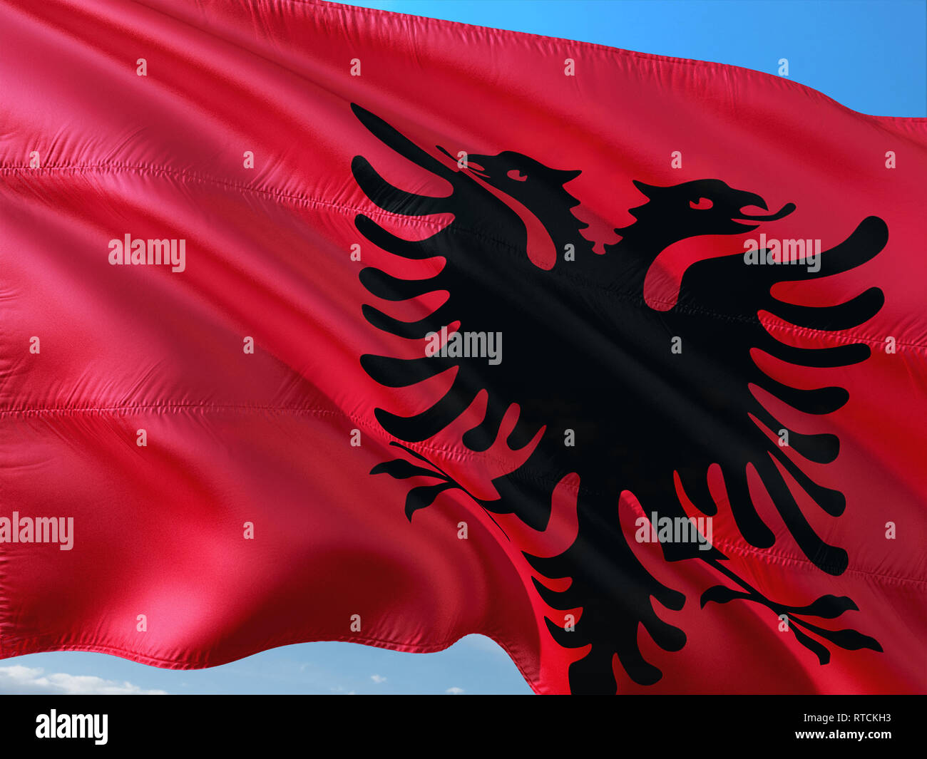Flag of Albania waving in the wind against deep blue sky. High quality ...