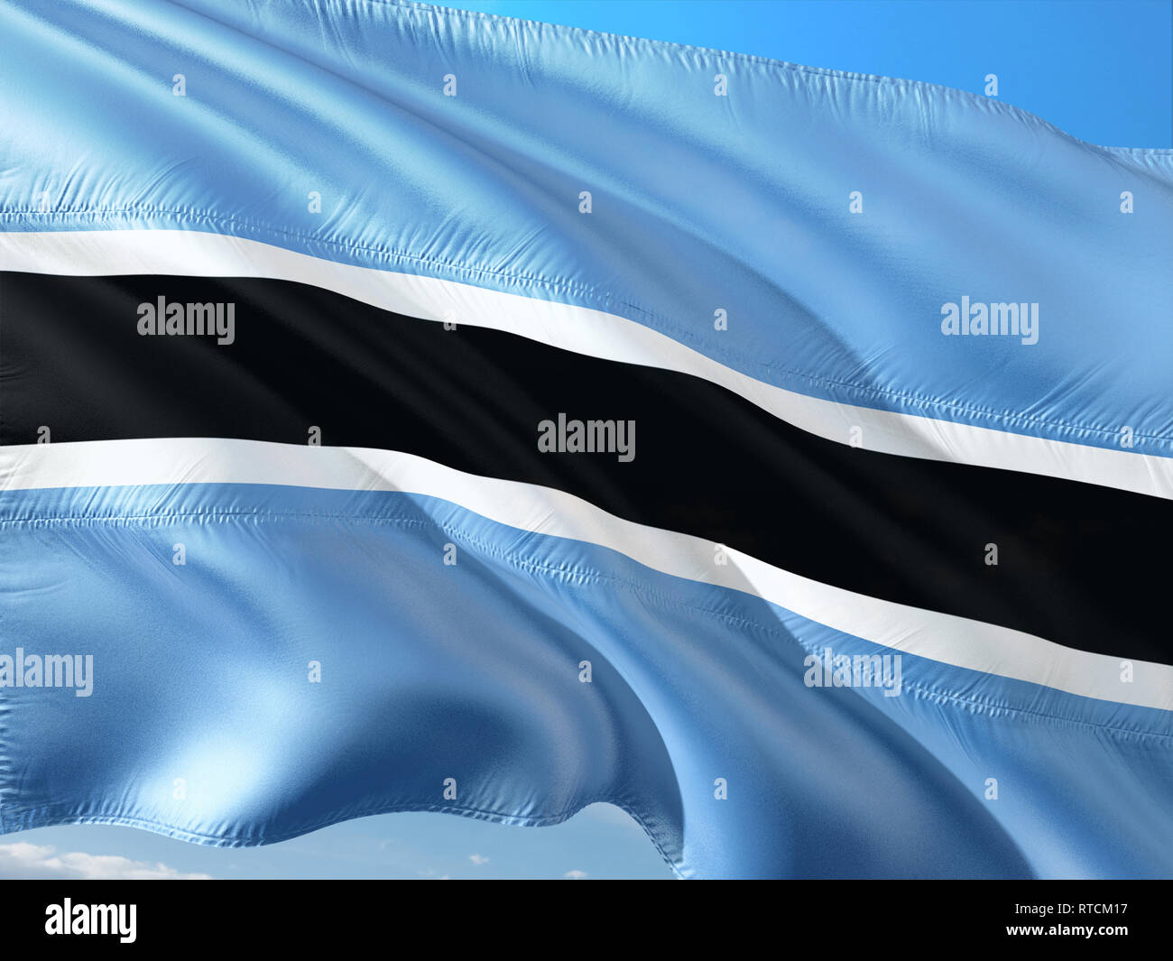 Flag of Botswana waving in the wind against deep blue sky. High quality ...