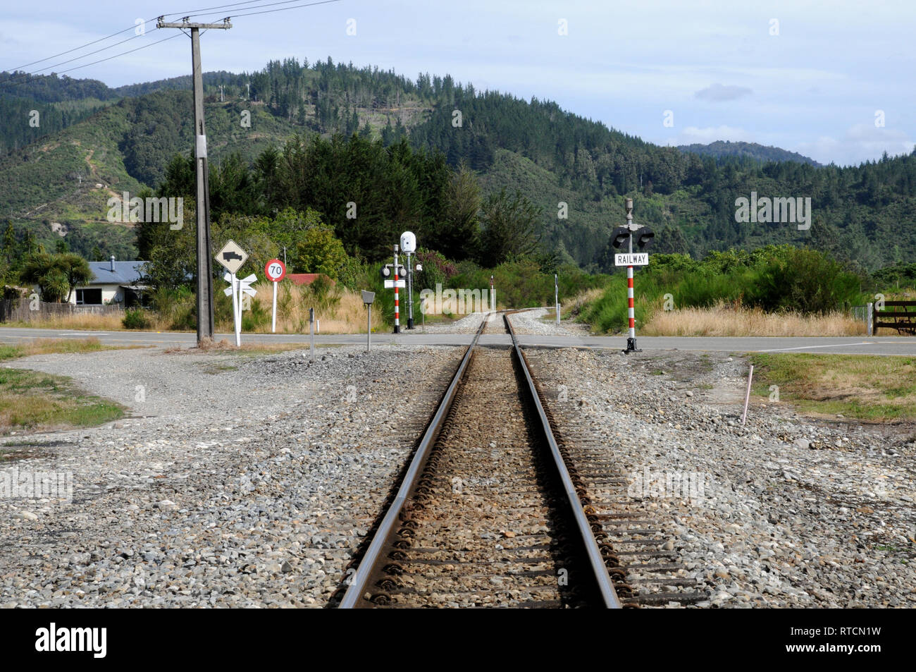 The tracks out of Reefton Station going in the direction of Greymouth and SH7. The line is the Stillwater-Westport line. Stock Photo
