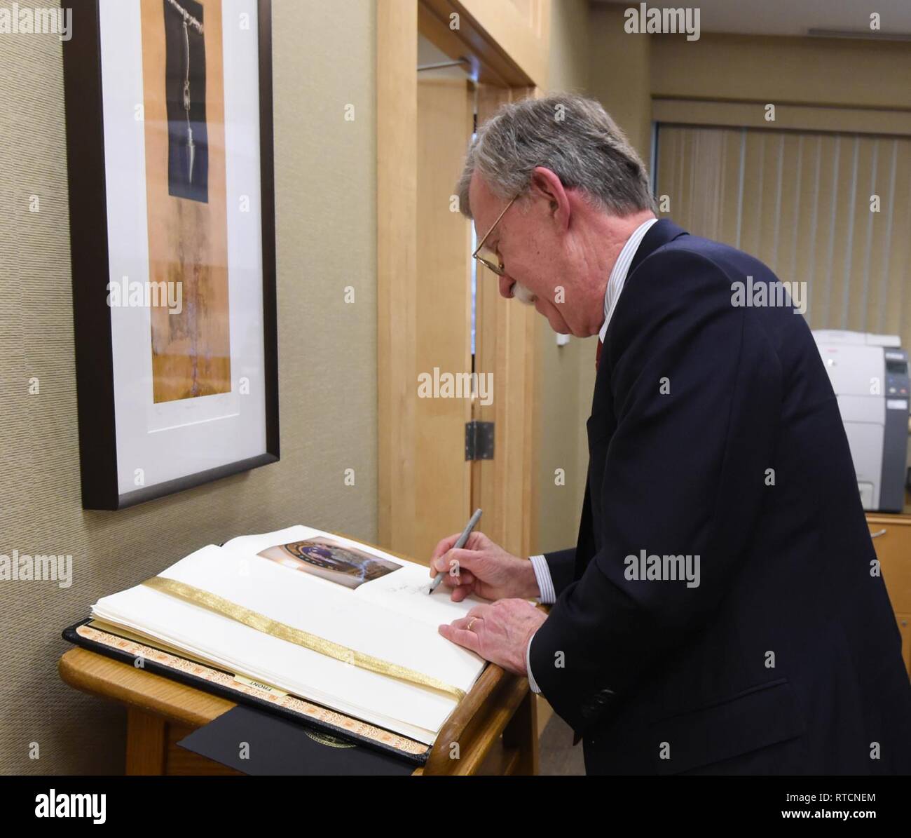 Ambassador John Bolton, National Security Advisor, signs the commander’s guest book during his visit to USSTRATCOM at Offutt Air Force Base, Neb., Feb. 14, 2019. The Ambassador observed USSTRATCOM’s combat-ready force, engaged in discussions with senior leaders and thanked warfighters for their service to the nation. Bolton’s visit also highlighted USSTRATCOM’s critical role in the National Security Strategy. Stock Photo