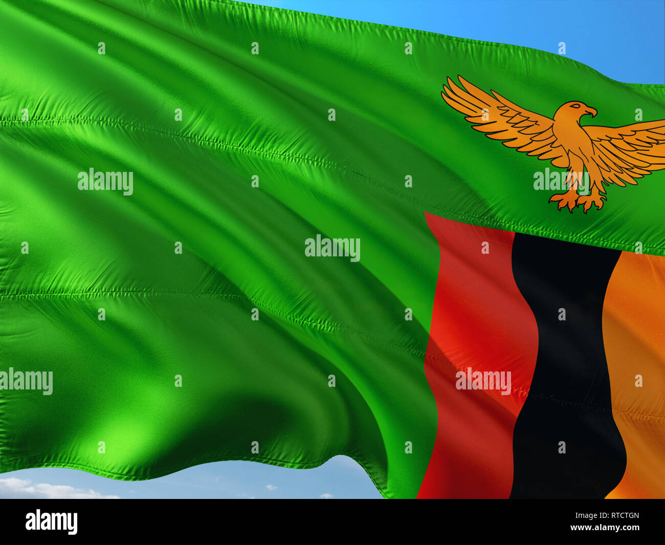 Flag of Zambia waving in the wind against deep blue sky. High quality ...