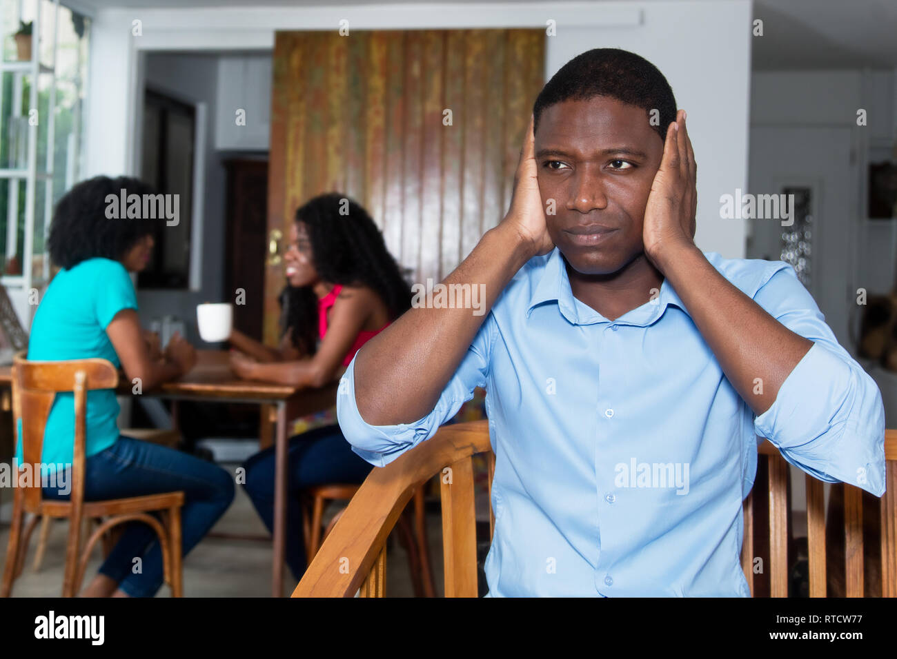 African american man with talking women at home Stock Photo