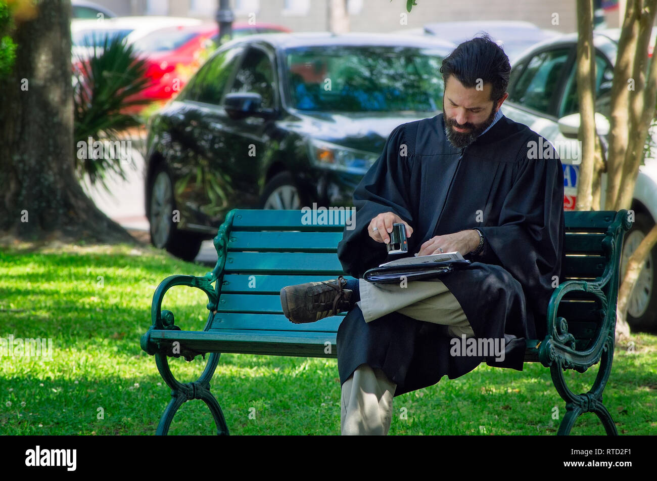 A preacher stamps a marriage certificate before a wedding at Marshall Park in Ocean Springs, Mississippi. Stock Photo