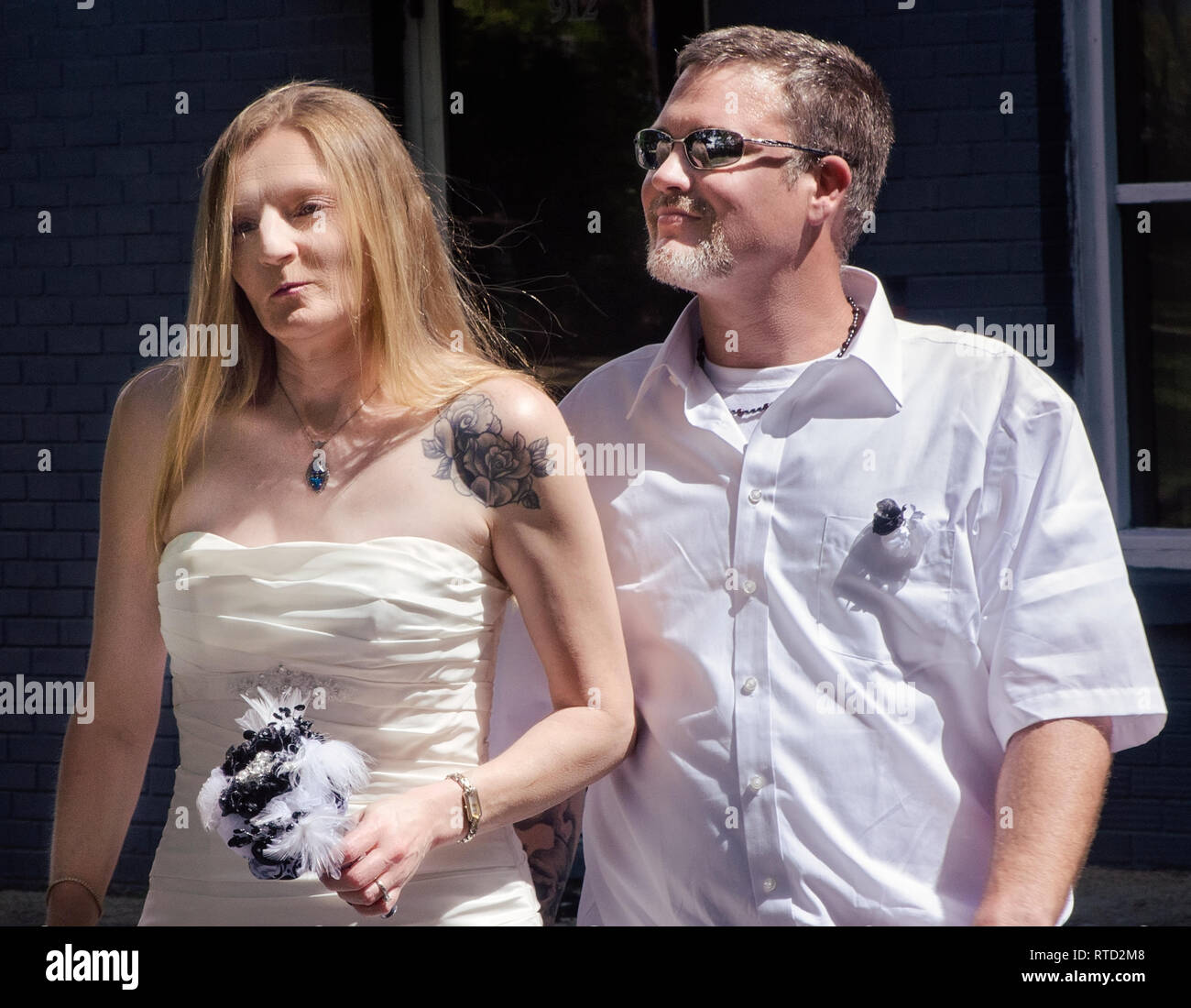 A bride and groom walk to their wedding ceremony at Marshall Park in Ocean Springs, Mississippi. Stock Photo