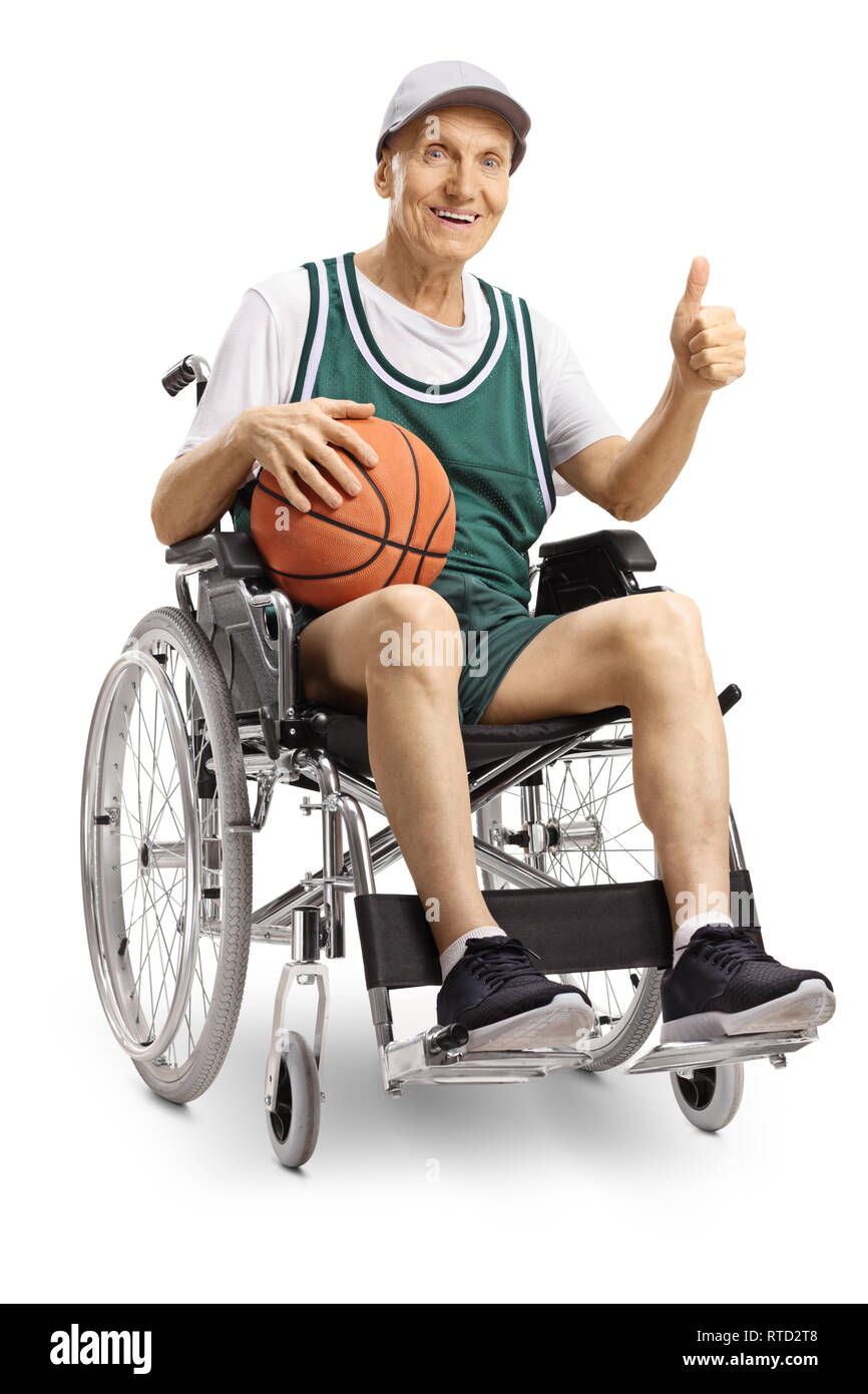 Disabled elderly man in a wheelchair holding a basketball and showing thumbs up isolated on white background Stock Photo