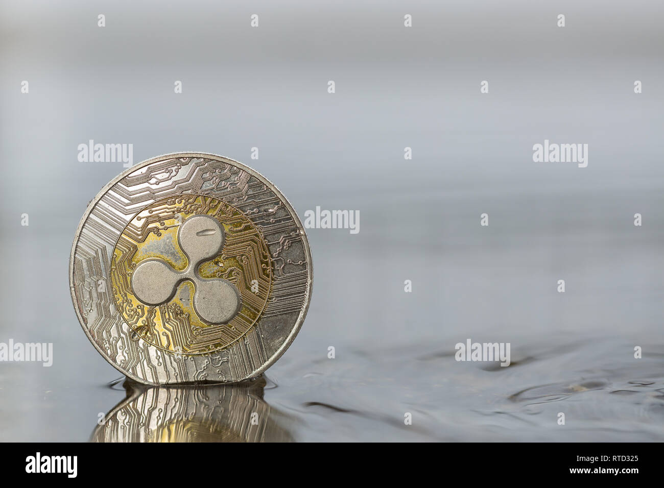 Ripple XRP cryptocurrency physical coin placed in water on the street Stock  Photo - Alamy