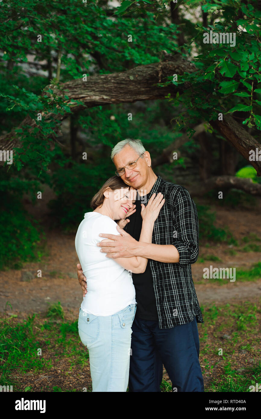 Senior couple walking together in a forest, close-up Stock Photo - Alamy