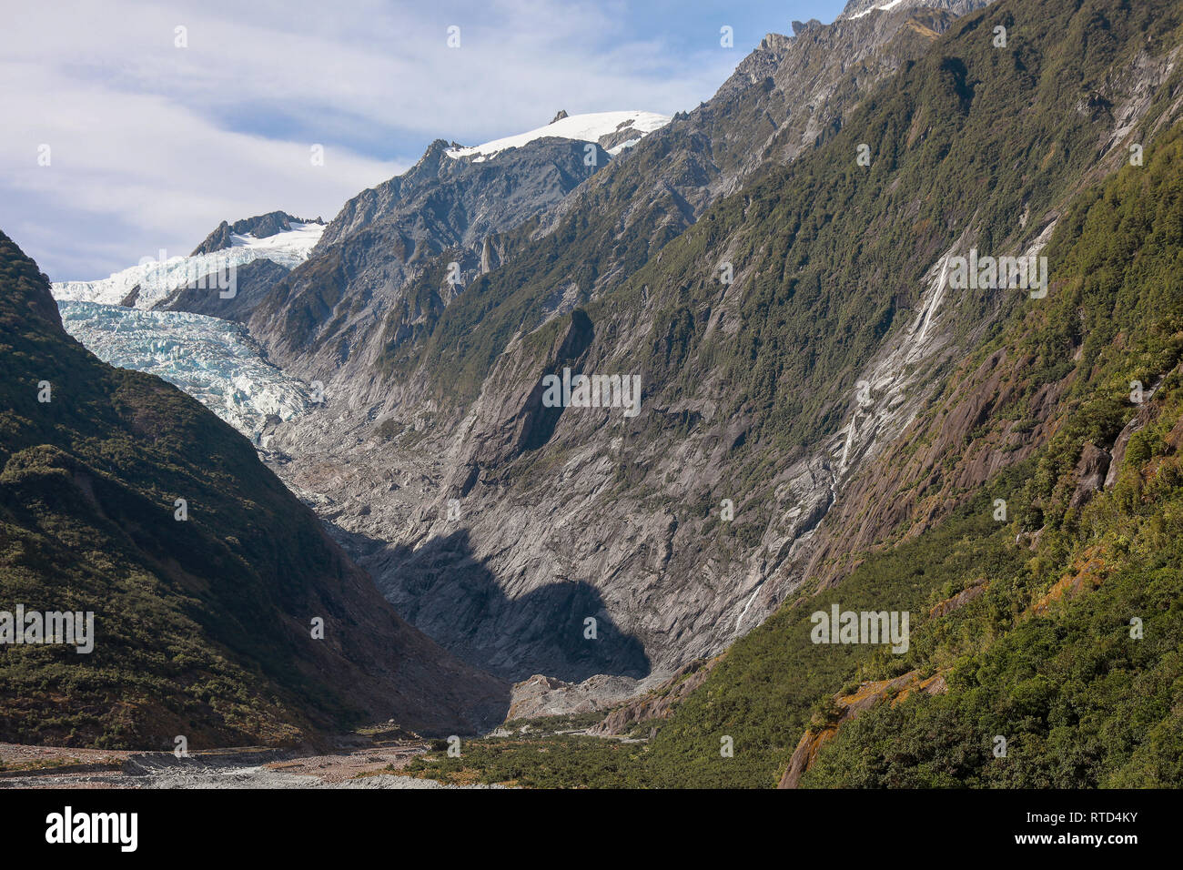 Franz Josef Glacier high in the mountains slowly coming down the vally New Zealand South Island Stock Photo