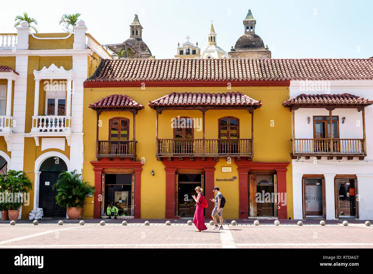 Cartagena Colombia,Plaza de La Aduana,public square,colonial architecture,red tile roof,wood balcony,couple,exploring,COL190119106 Stock Photo