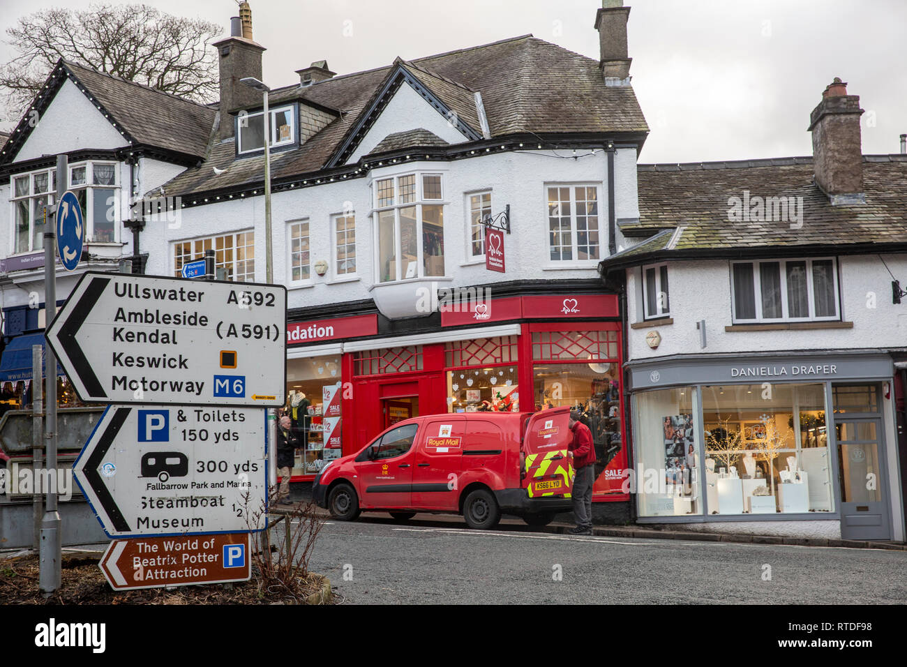 Bowness on windermere town centre, Royal Mail postman with his van collects mail,Bowness,Cumbria,England Stock Photo