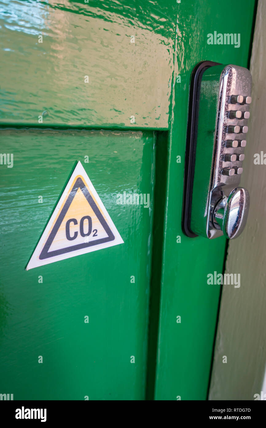 CO2 triangle warning sign and Digital Keypad Door Lock on an Old