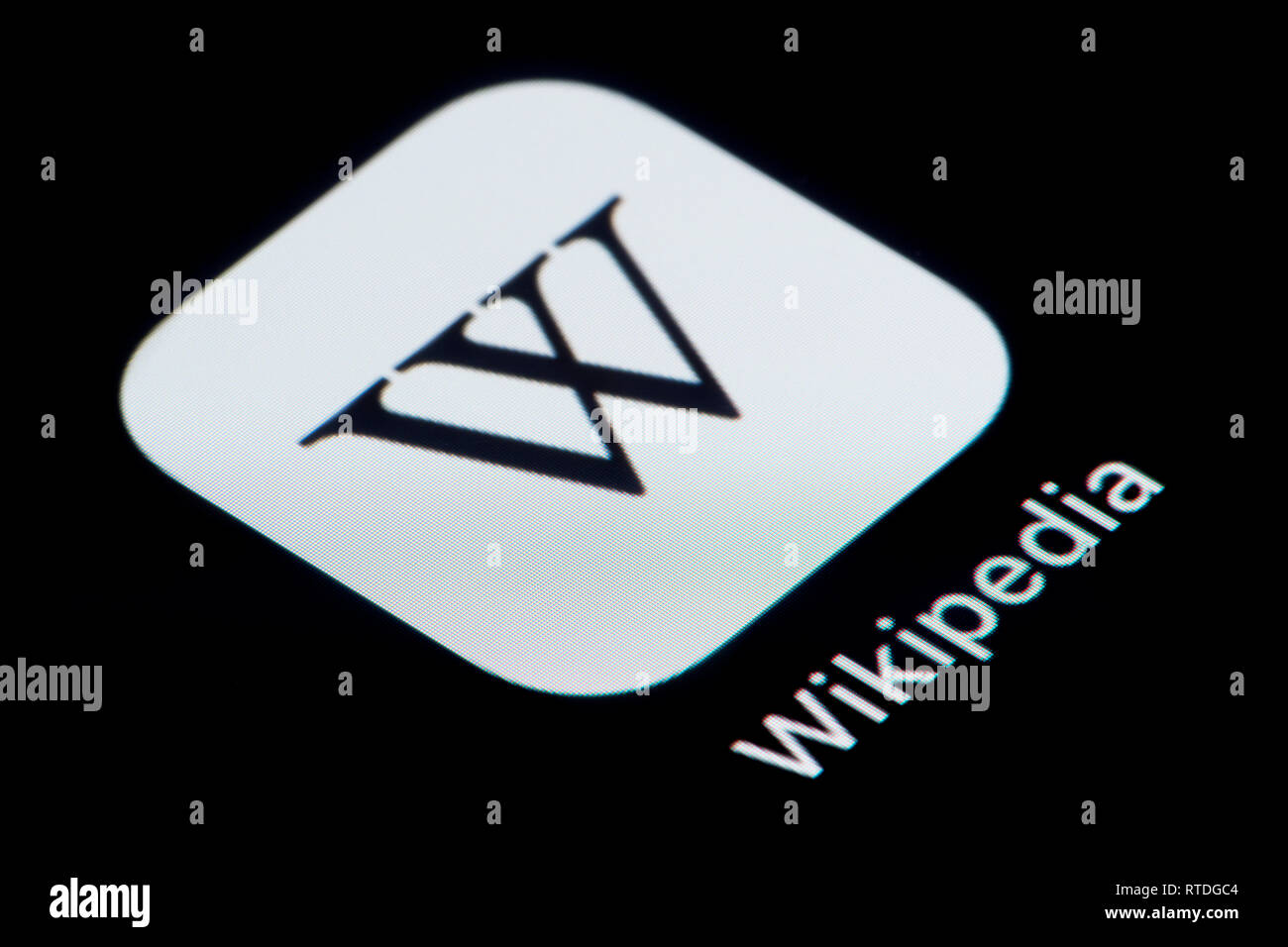A close-up shot of the Wikipedia app icon, as seen on the screen of a smart phone (Editorial use only) Stock Photo