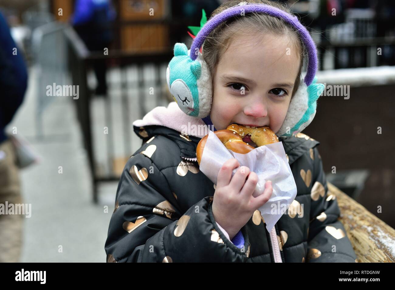 Chicago, Illinois, USA. Little girl eating a freshly made gourmet