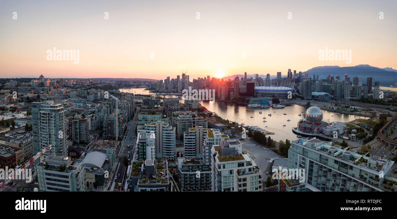 Aerial Panoramic view of a modern city during a sunny summer sunset ...
